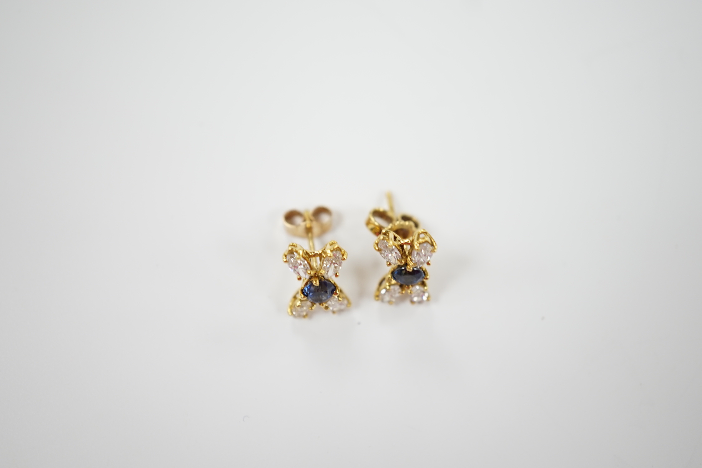 A modern pair of 18ct gold, sapphire and diamond cluster set 'X' ear studs, 12mm, gross weight 2.2 grams.